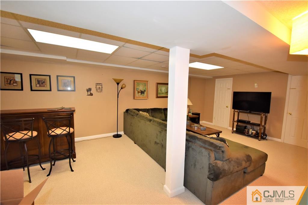 304 Hawthorne Road North Brunswick, NJ 08902 - Photo 21 of 25 a living room with furniture and a flat screen tv