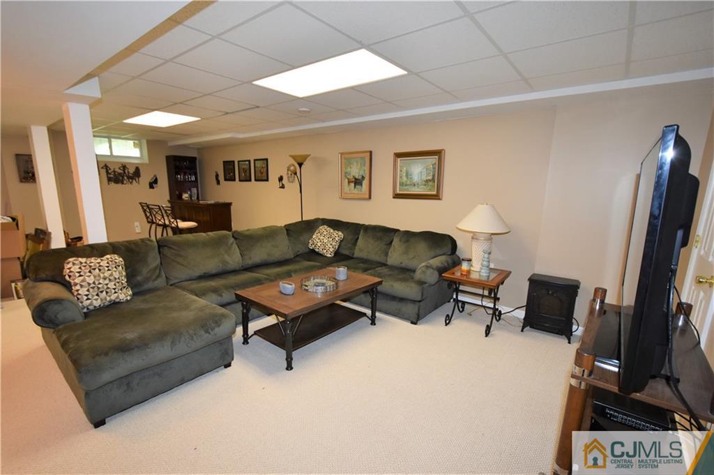 304 Hawthorne Road North Brunswick, NJ 08902 - Photo 22 of 25 a living room with furniture and a flat screen tv