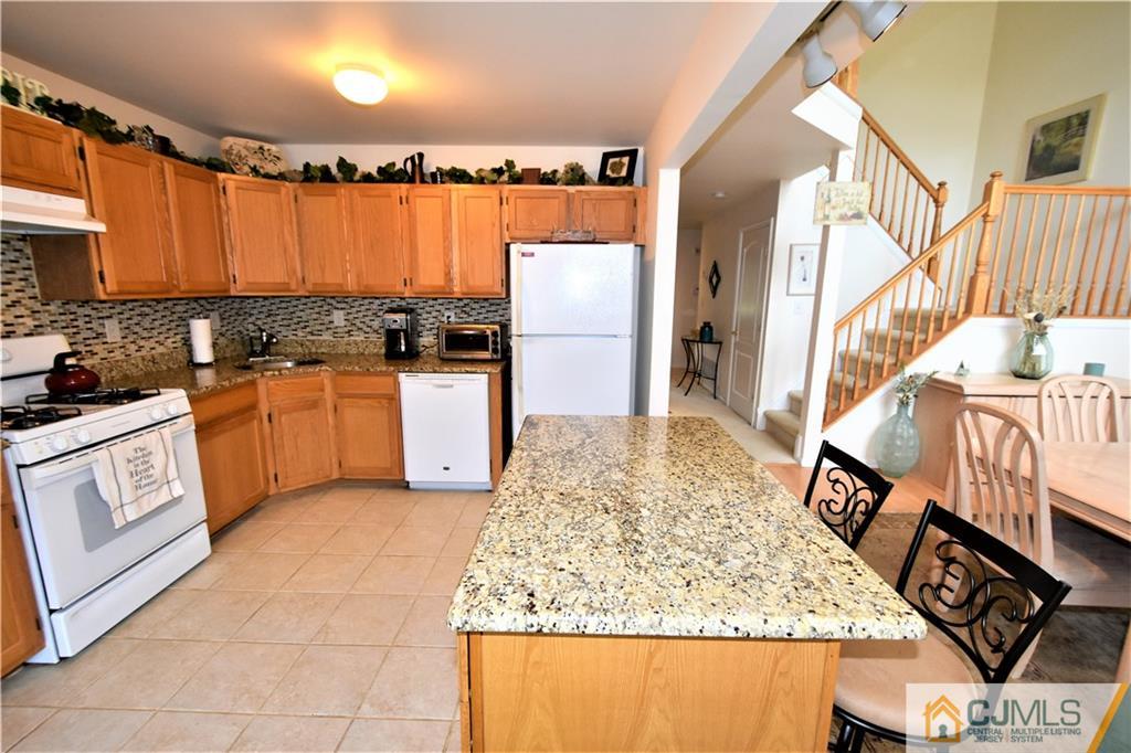 304 Hawthorne Road North Brunswick, NJ 08902 - Photo 10 of 25 a kitchen with stainless steel appliances granite countertop a stove a sink and a refrigerator