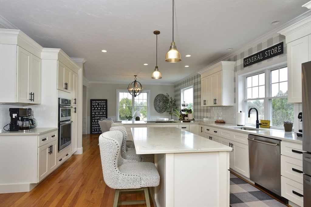 5 Tailwind Circle Norfolk, MA 02056 - Photo 11 of 40 a large kitchen with kitchen island a large counter top space a sink stainless steel appliances and cabinets