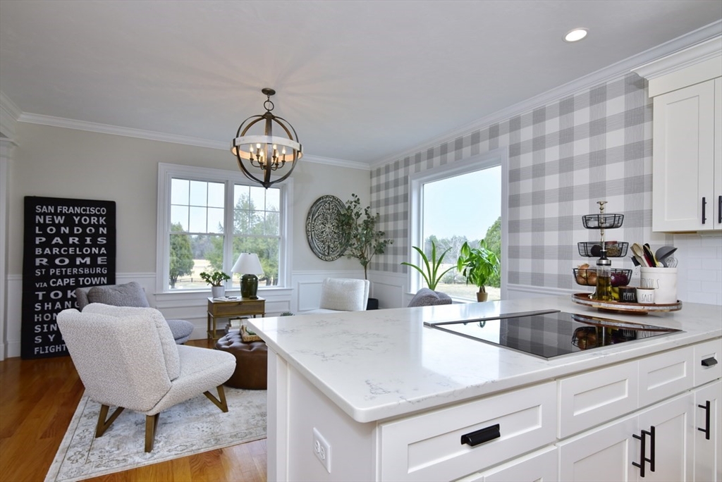 5 Tailwind Circle Norfolk, MA 02056 - Photo 12 of 40 a kitchen with a table chairs and a stove