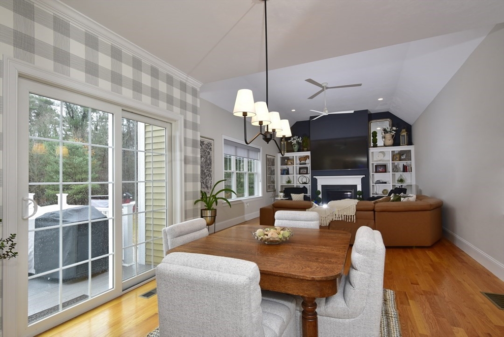 5 Tailwind Circle Norfolk, MA 02056 - Photo 13 of 40 a living room with furniture a chandelier and a fireplace
