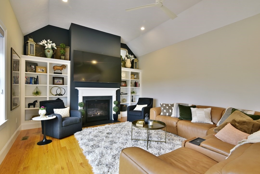 5 Tailwind Circle Norfolk, MA 02056 - Photo 15 of 40 a living room with furniture and a fireplace