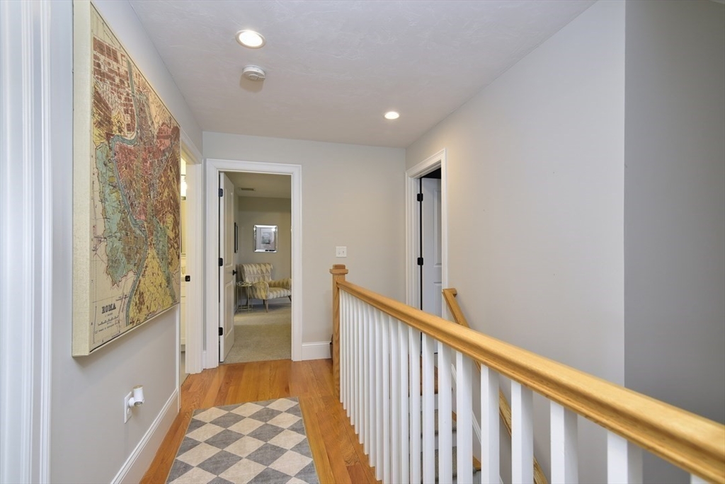 5 Tailwind Circle Norfolk, MA 02056 - Photo 21 of 40 a view of hallway with wooden floor and a bathroom