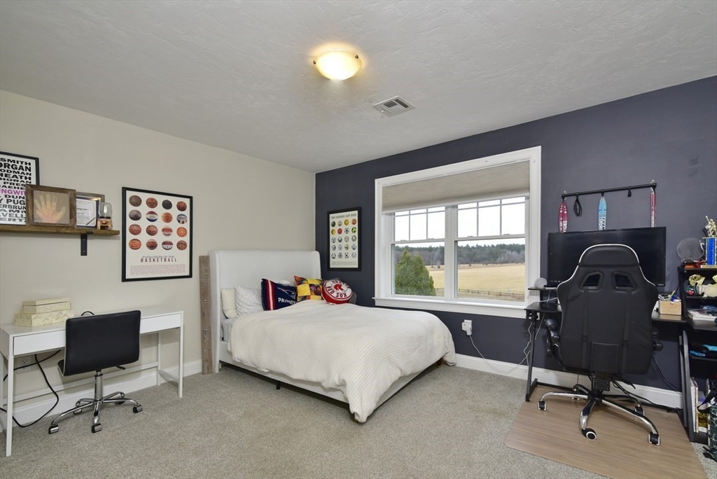 5 Tailwind Circle Norfolk, MA 02056 - Photo 23 of 40 a bedroom with a bed and a desk