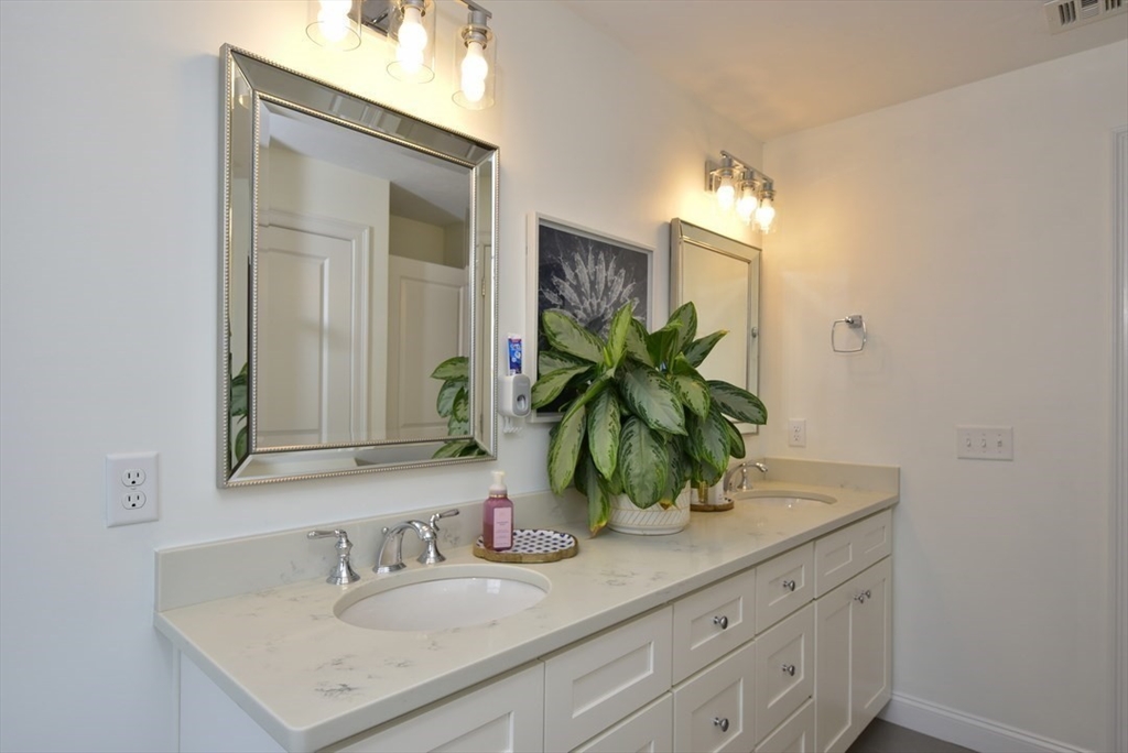 5 Tailwind Circle Norfolk, MA 02056 - Photo 25 of 40 a bathroom with a sink and a mirror