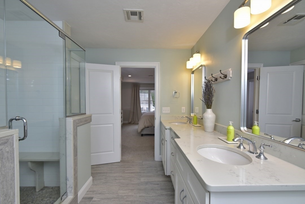 5 Tailwind Circle Norfolk, MA 02056 - Photo 26 of 40 a en suite bathroom with a double vanity sink and a mirror
