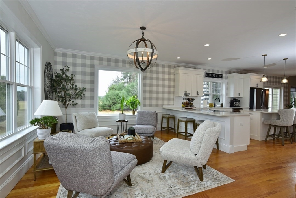 5 Tailwind Circle Norfolk, MA 02056 - Photo 7 of 40 a living room with furniture a chandelier and a dining table