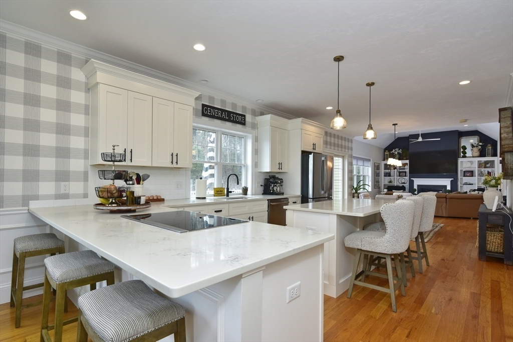 5 Tailwind Circle Norfolk, MA 02056 - Photo 8 of 40 a kitchen with a sink a counter space appliances and cabinets