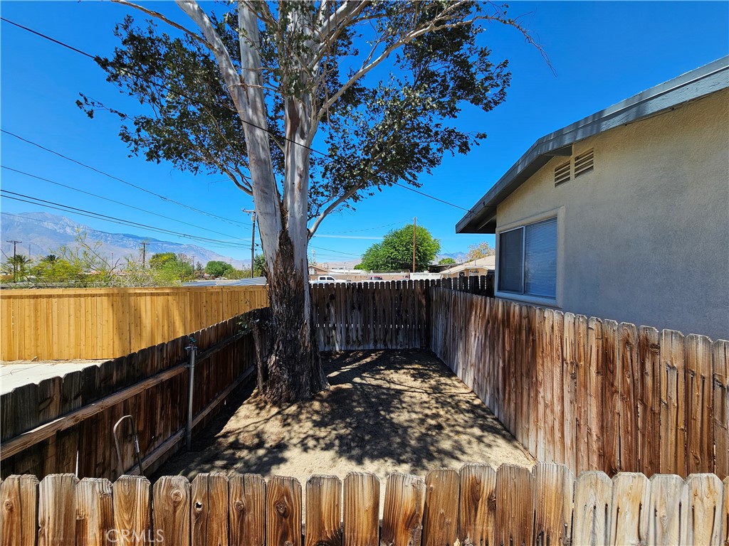 66051 3rd Street, Unit A Desert Hot Springs, CA 92240 - Photo 12 of 14 a view of a pathway of a wooden fence