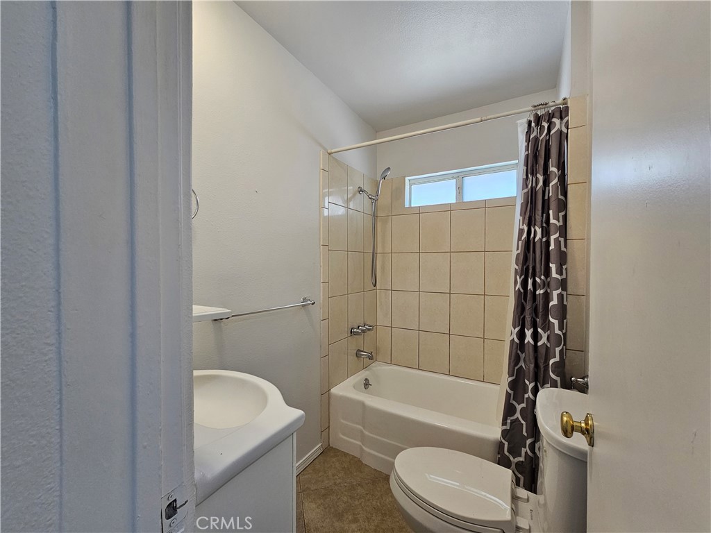 66051 3rd Street, Unit A Desert Hot Springs, CA 92240 - Photo 10 of 14 a bathroom with a toilet and a bathtub