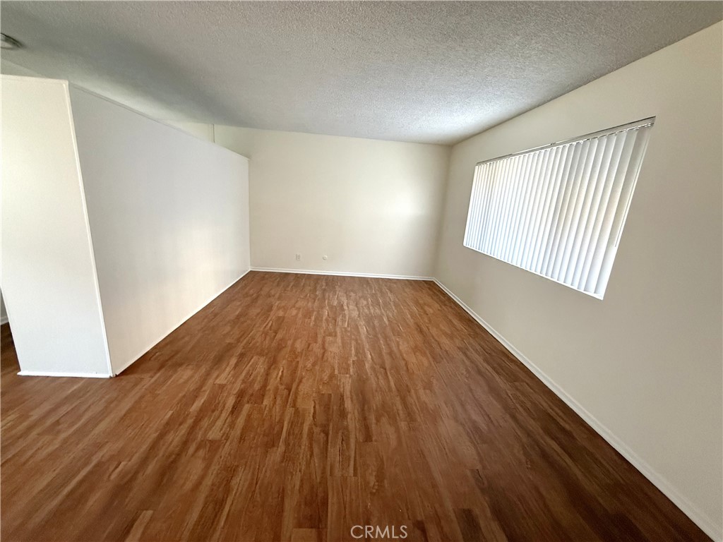 4015 137th Street, Unit 102 Hawthorne, CA 90250 - Photo 12 of 21 an empty room with wooden floor and windows