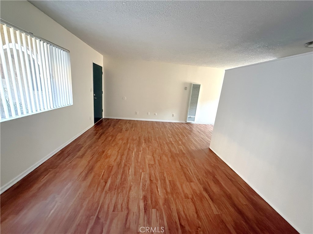 4015 137th Street, Unit 102 Hawthorne, CA 90250 - Photo 13 of 21 a view of empty room with wooden floor and fan