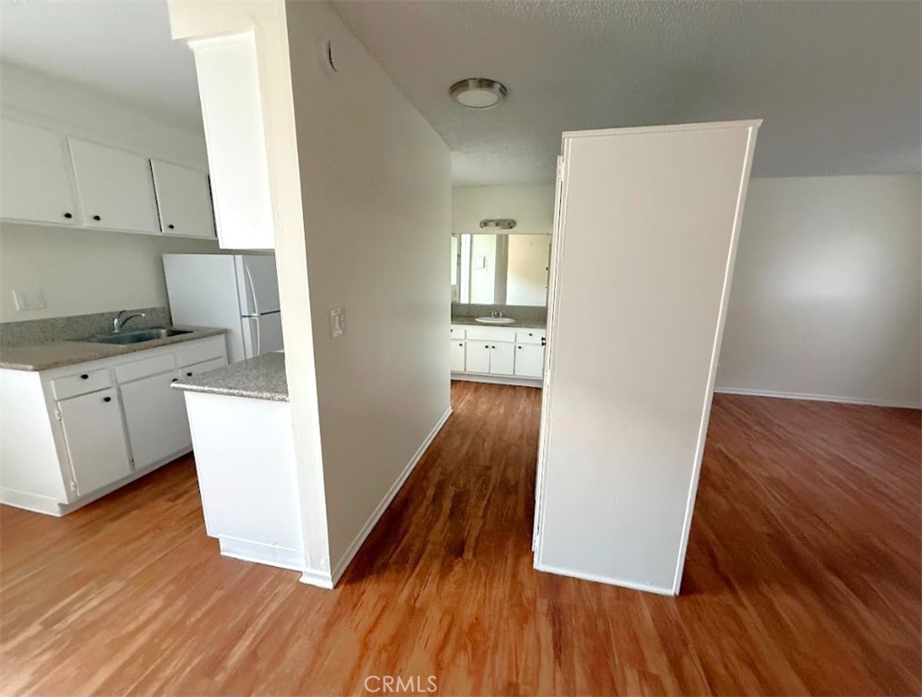 4015 137th Street, Unit 102 Hawthorne, CA 90250 - Photo 15 of 21 a view of kitchen and wooden floor