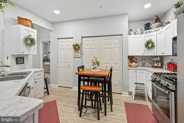 a kitchen with a refrigerator and a stove top oven