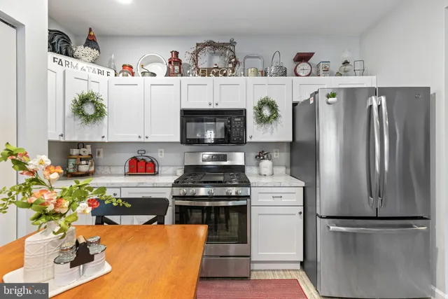 a kitchen with stainless steel appliances granite countertop a refrigerator and a sink
