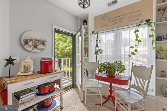 a living room with furniture and paintings on the wall