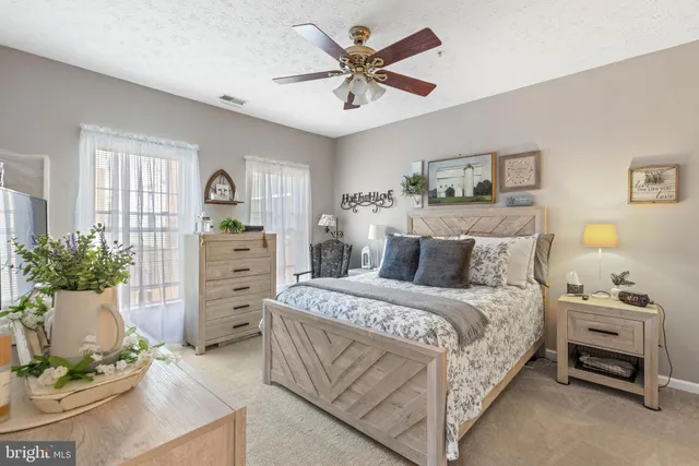 a spacious bedroom with a bed and a dresser in it
