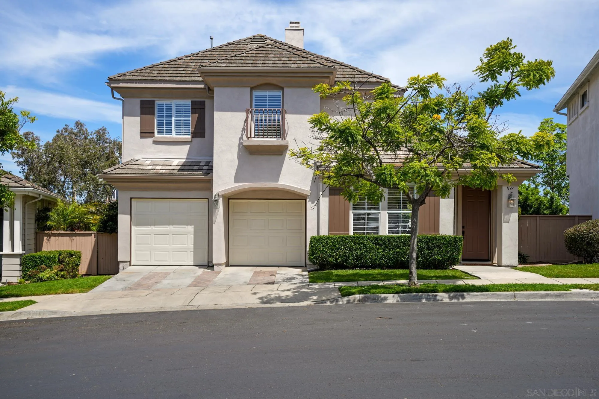 1137 Pacifica Place Encinitas, CA 92024 - Photo 1 of 31 a front view of a house with a yard and garage