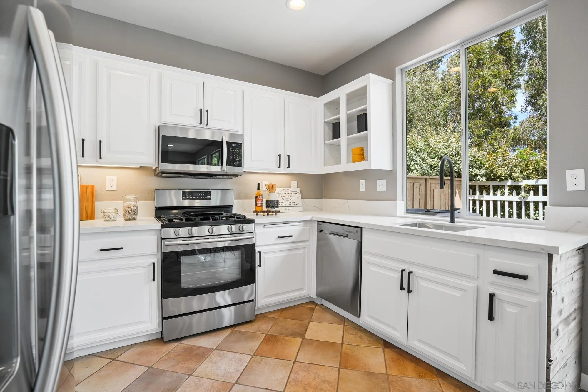1137 Pacifica Place Encinitas, CA 92024 - Photo 14 of 31 a kitchen with appliances cabinets and a sink