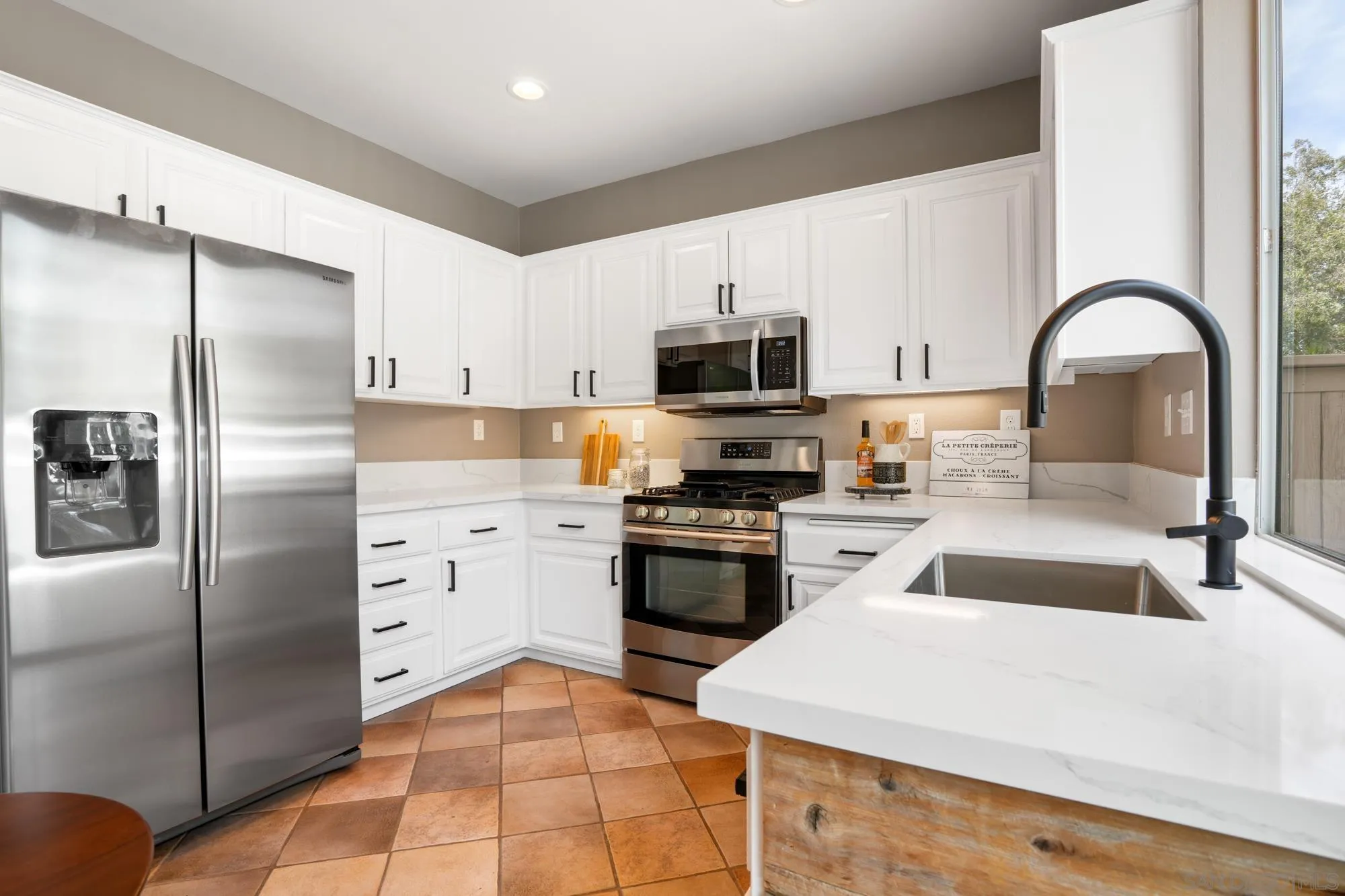 1137 Pacifica Place Encinitas, CA 92024 - Photo 15 of 31 a kitchen with a refrigerator stove and sink