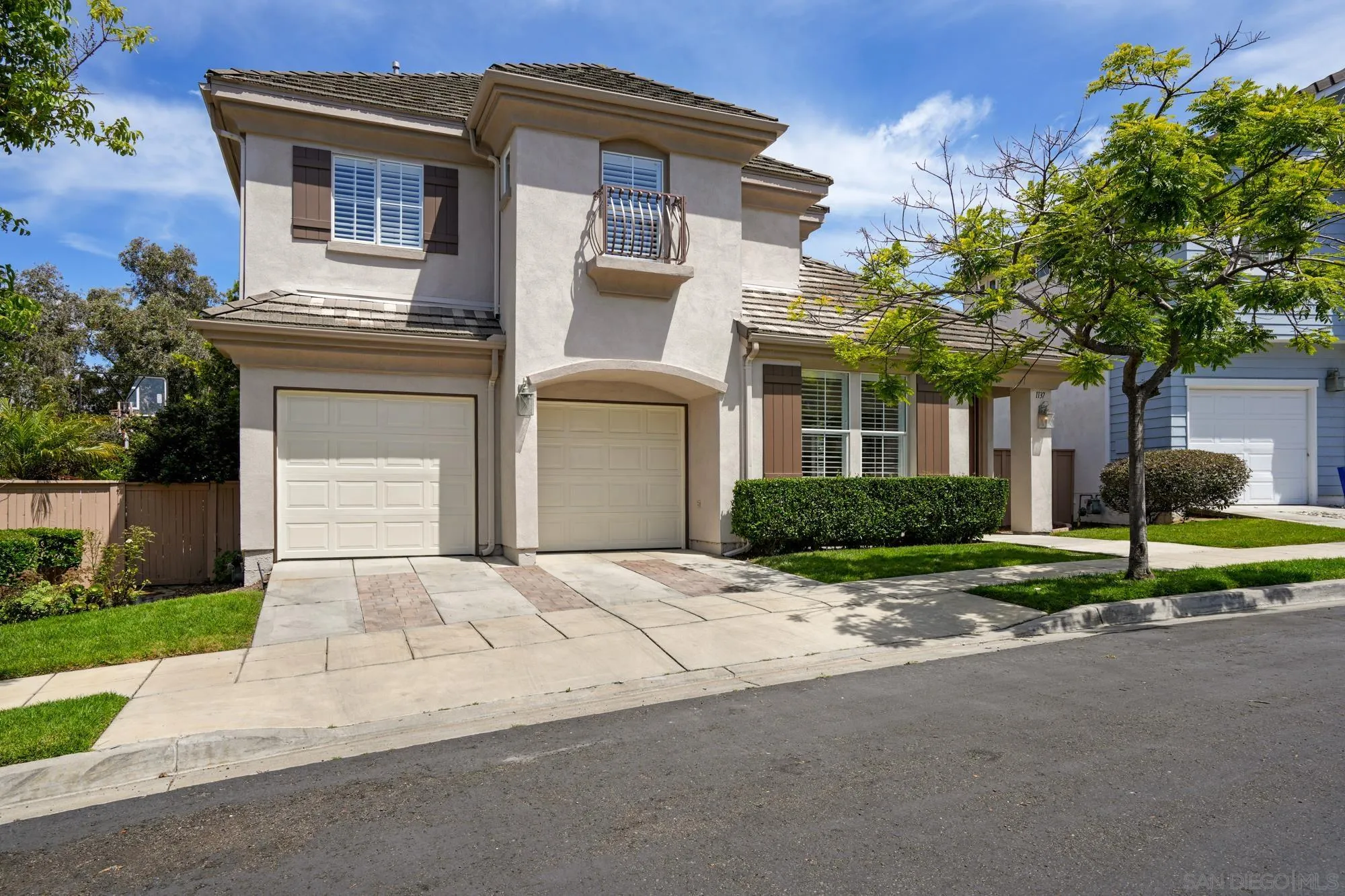 1137 Pacifica Place Encinitas, CA 92024 - Photo 2 of 31 a front view of a house with a yard and garage