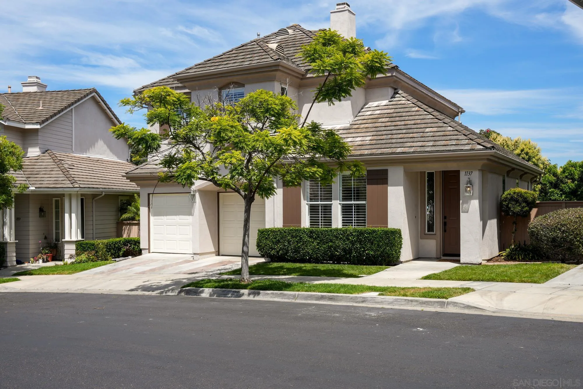 1137 Pacifica Place Encinitas, CA 92024 - Photo 3 of 31 a front view of a house with a yard and garage