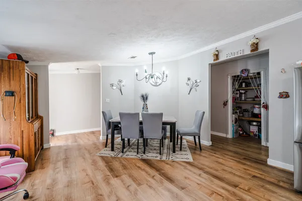 a view of a dining room with furniture and wooden floor