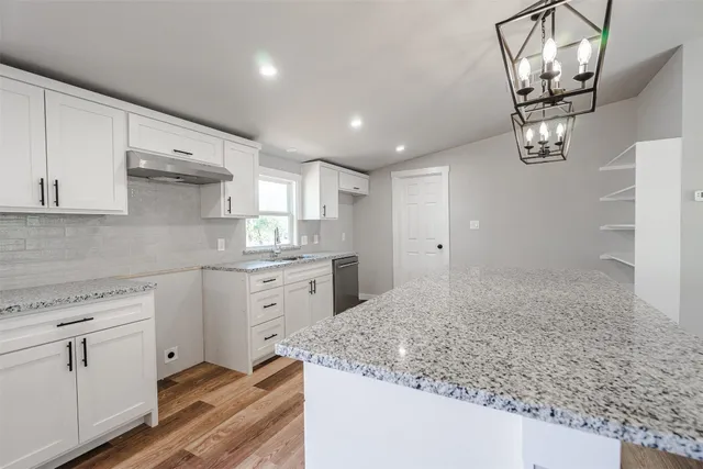 a kitchen with sink cabinets and appliances