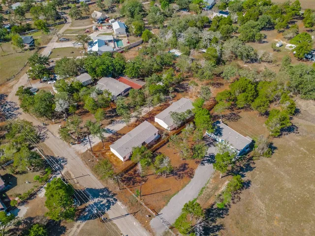 an aerial view of residential houses with outdoor space