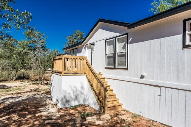 a view of a house with a small yard