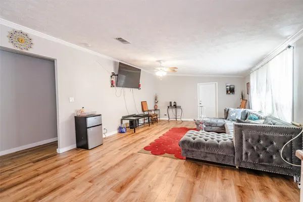 a bedroom with furniture and a wooden floor