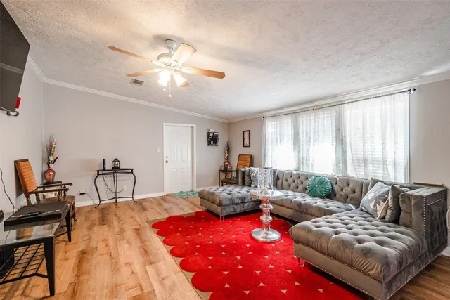 a bedroom with furniture and a large window