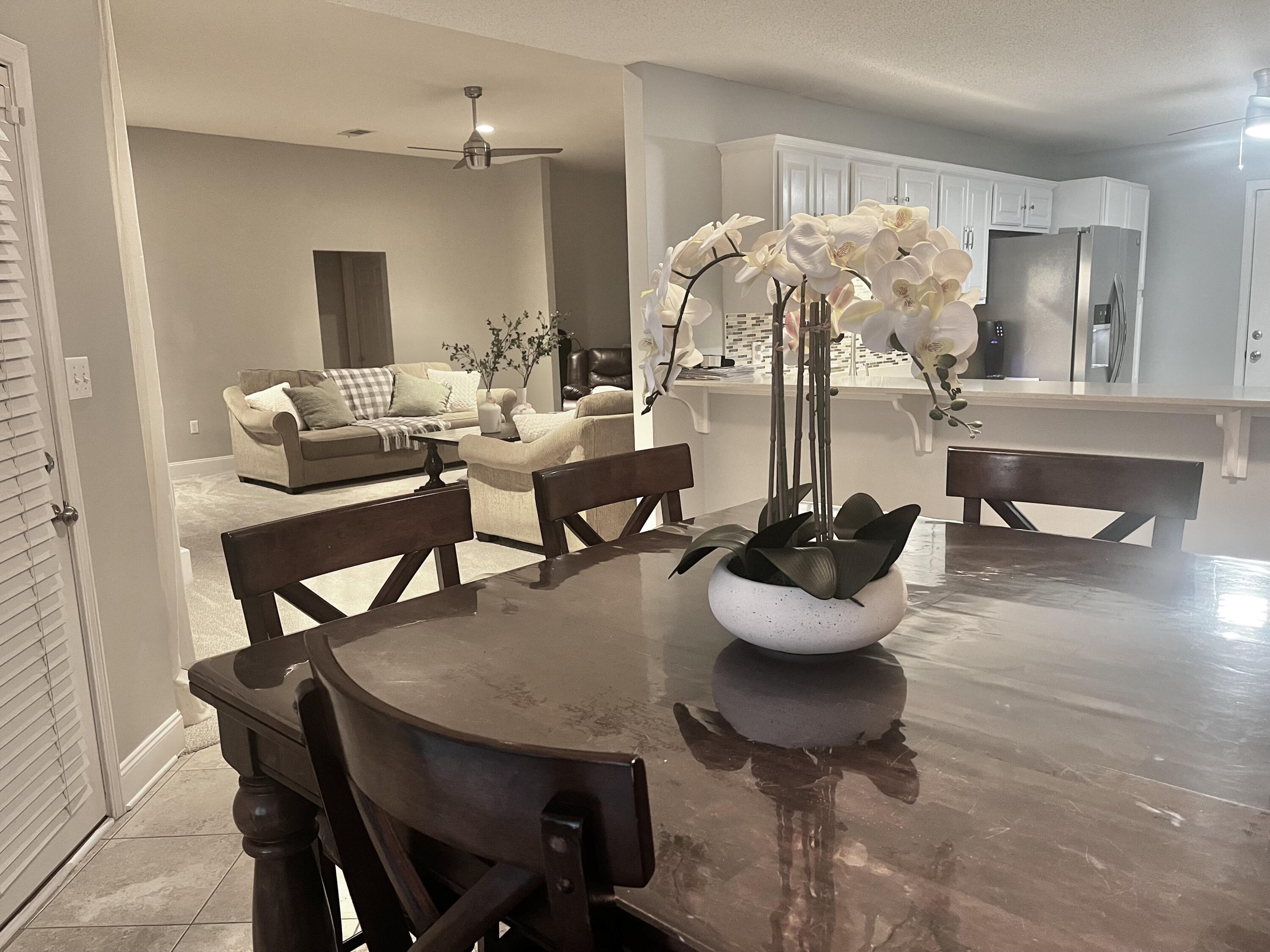 449 Ruckel Drive Niceville, FL 32578 - Photo 11 of 38 a view of a dining room with furniture and wooden floor