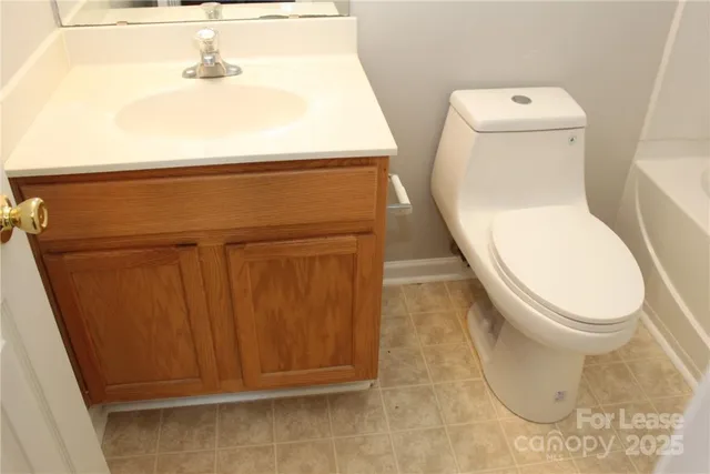 a white toilet sitting next to a sink