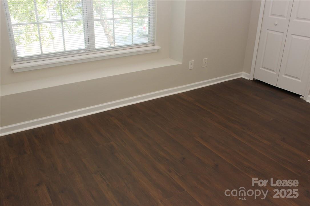 17013 Turning Stick Court Charlotte, NC 28213 - Photo 17 of 27 an empty room with wooden floor and windows