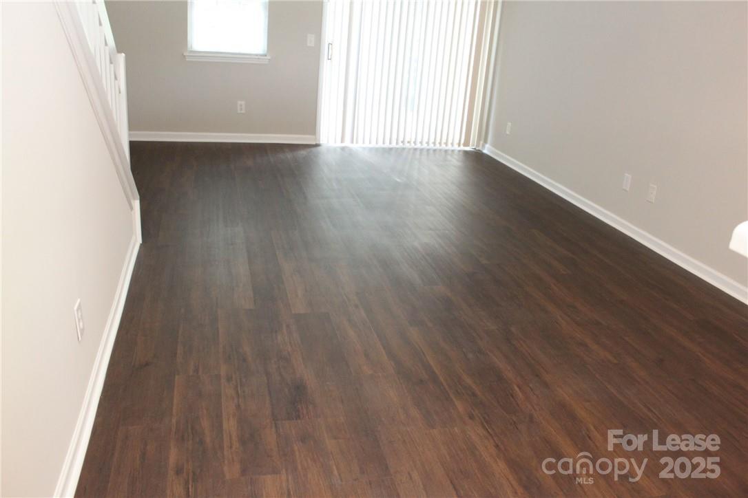 17013 Turning Stick Court Charlotte, NC 28213 - Photo 2 of 27 an empty room with wooden floor and windows