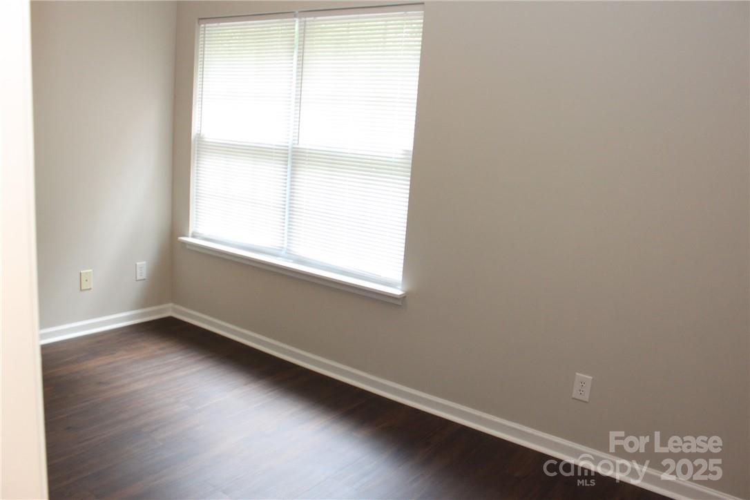 17013 Turning Stick Court Charlotte, NC 28213 - Photo 24 of 27 an empty room with wooden floor and windows