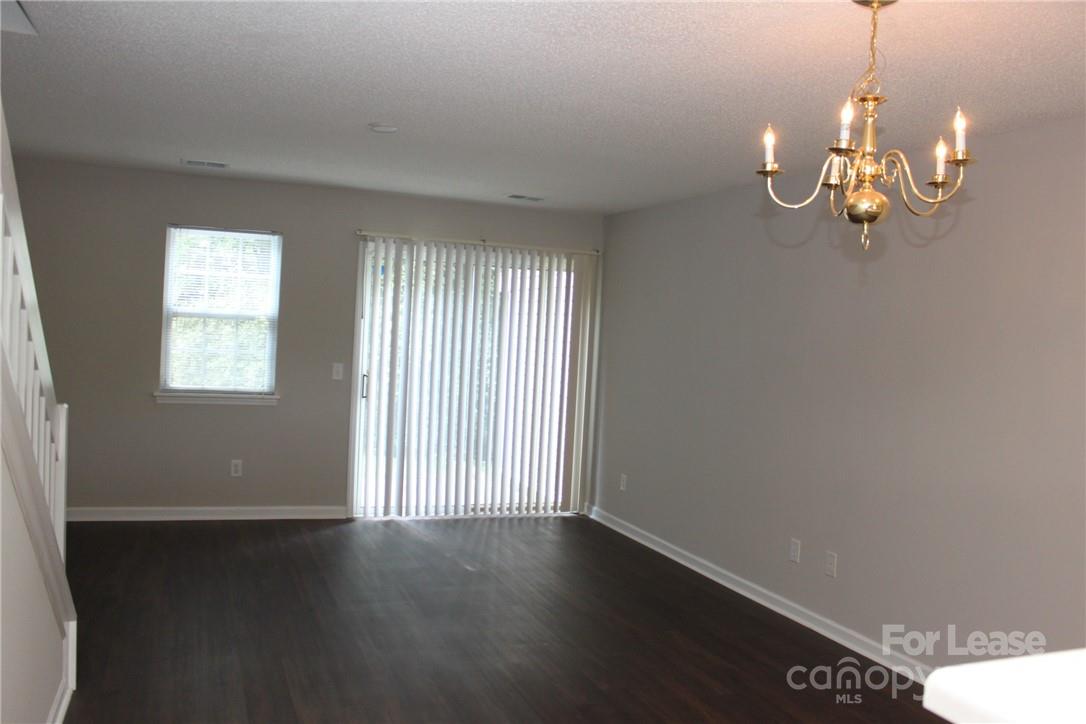 17013 Turning Stick Court Charlotte, NC 28213 - Photo 3 of 27 an empty room with wooden floor and windows