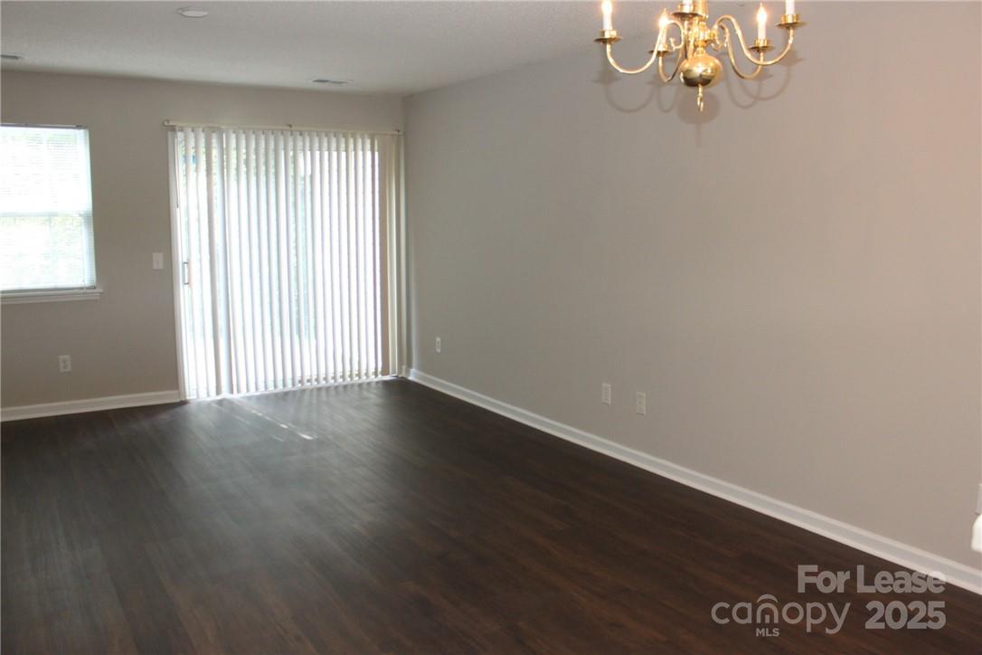 17013 Turning Stick Court Charlotte, NC 28213 - Photo 4 of 27 an empty room with wooden floor and windows