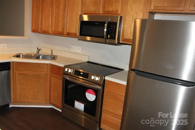 a kitchen with stainless steel appliances a refrigerator and a stove