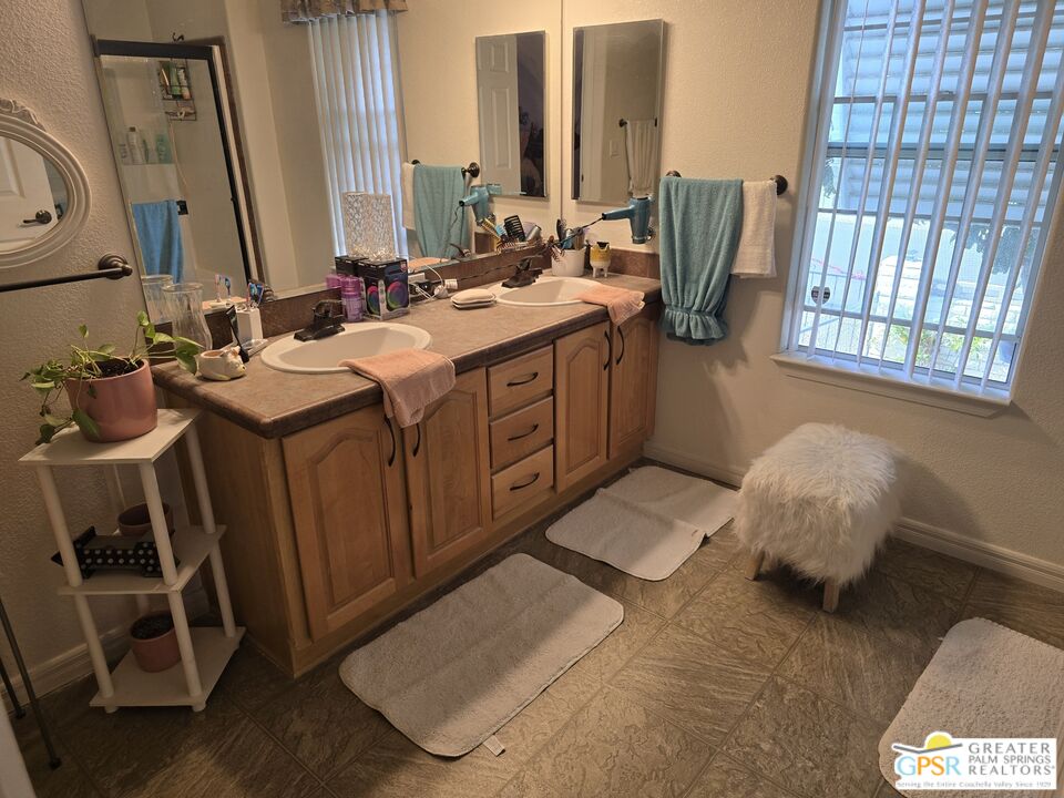 26012 Chelsea Way Hemet, CA 92544 - Photo 15 of 27 a bathroom with a double vanity sink and a mirror