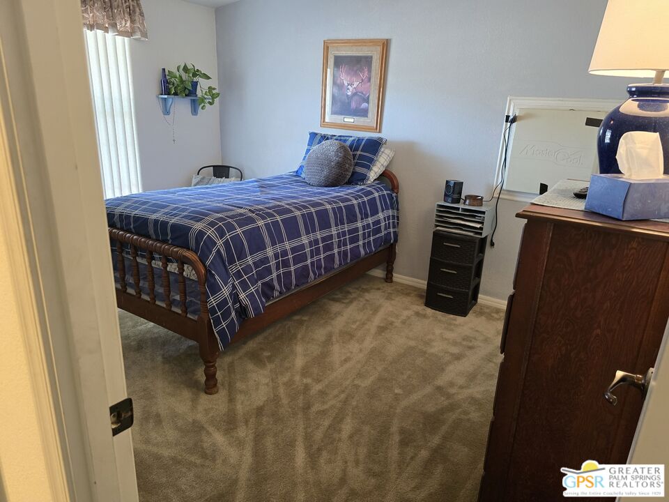 26012 Chelsea Way Hemet, CA 92544 - Photo 18 of 27 a bedroom with a bed wooden floor and lamp
