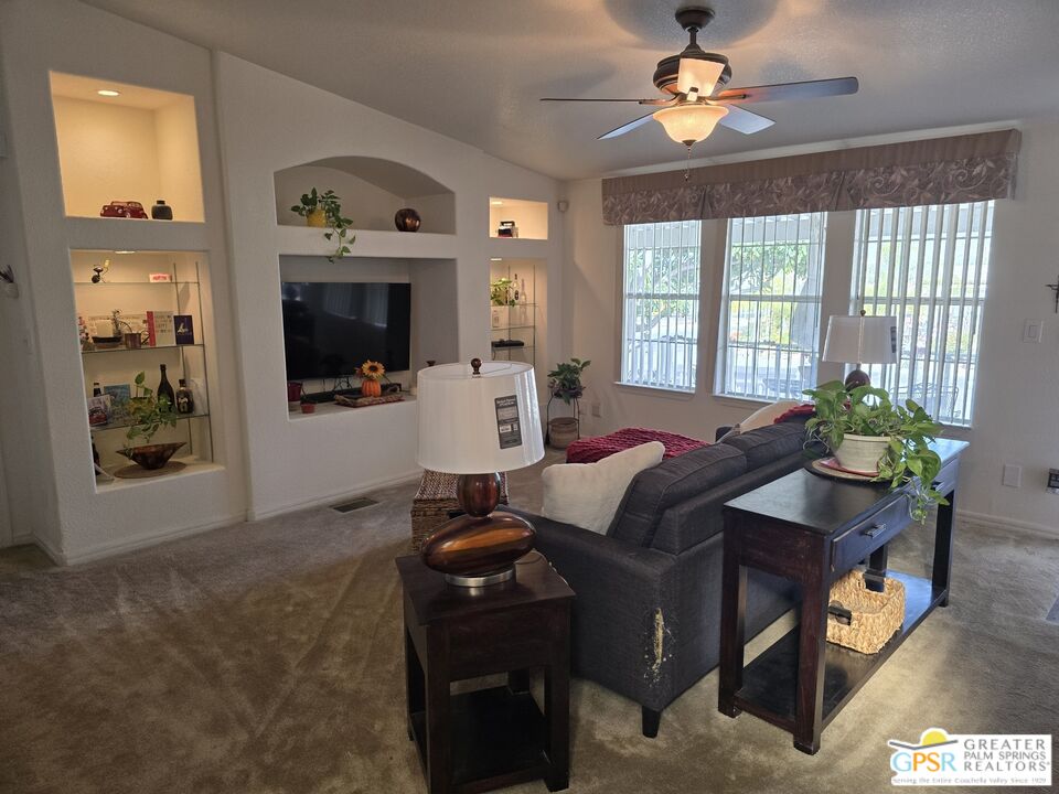 26012 Chelsea Way Hemet, CA 92544 - Photo 9 of 27 a living room with furniture a chandelier and a window