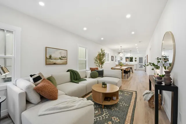 a bedroom with a bed a mirror and a window