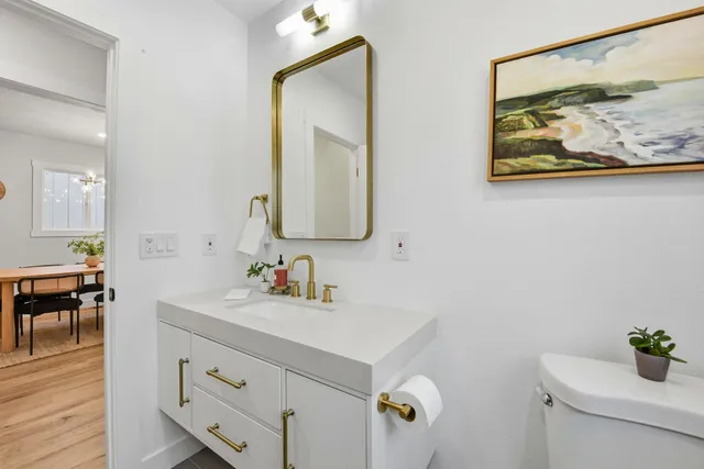 a view of a patio with table and chairs with wooden floor and fence