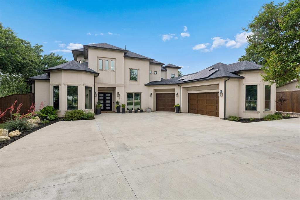 6700 Herbert Road Colleyville, TX 76034 - Photo 1 of 32 a front view of a house with a yard and garage