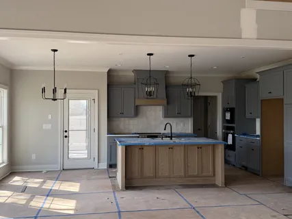 a kitchen with stainless steel appliances granite countertop a sink and a refrigerator