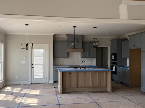 a kitchen with stainless steel appliances granite countertop a sink and a refrigerator