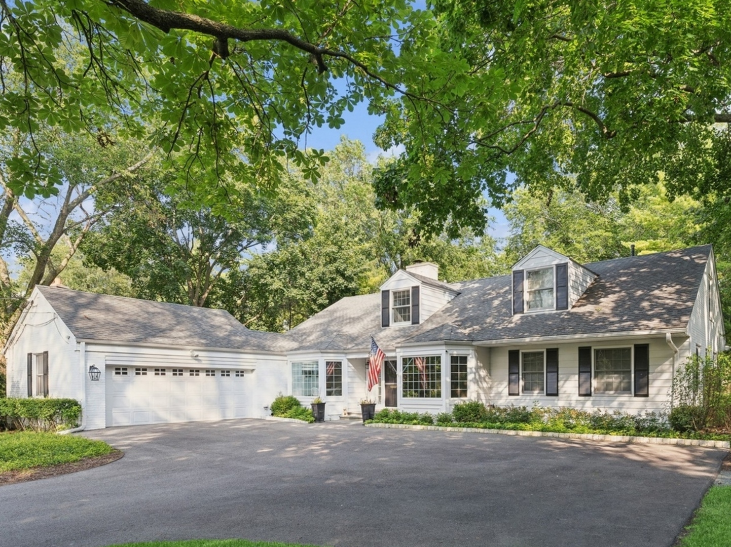 269 Locust Road Winnetka, IL 60093 - Photo 1 of 26 a front view of a house with a garden